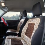 High-quality car seat wooden beads installed on a taxi driver seat for summer comfort and ventilation in Mumbai; India.